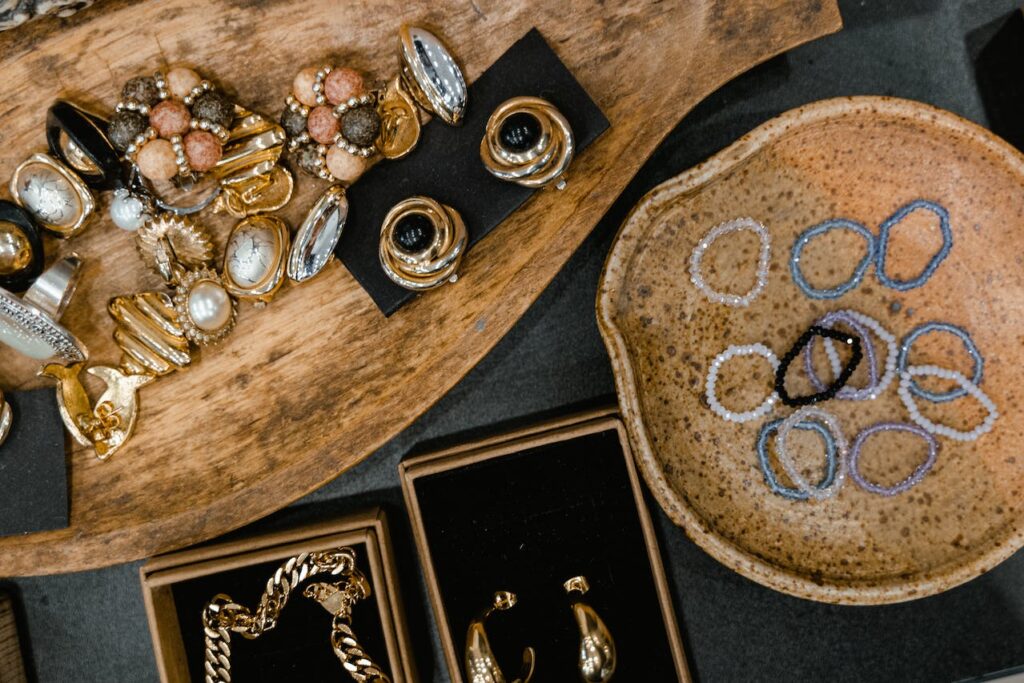 Photo by MART  PRODUCTION: https://www.pexels.com/photo/top-view-of-handmade-jewelry-lying-on-wooden-and-ceramic-trays-7679889/